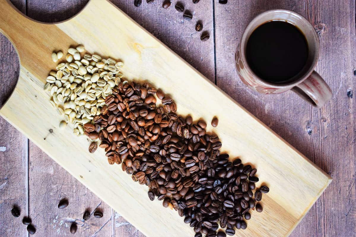 Coffee beans roasting stages on wooden board